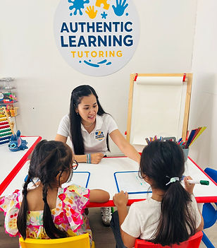 Teacher teaching 2 students