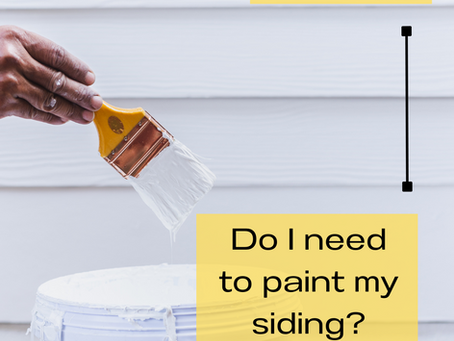 A hand holding a paintbrush with white paint