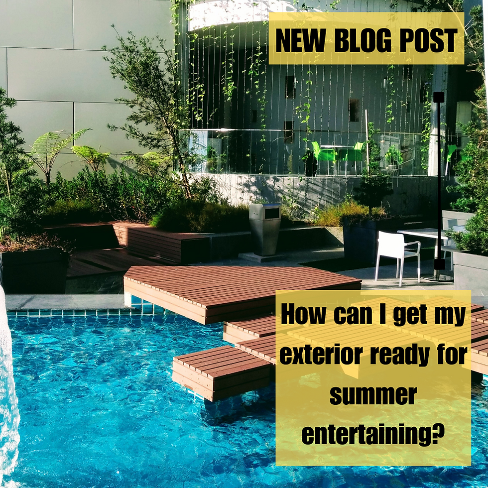 Modern patio with a turquoise pool, decks, green plants, and a white chair. 