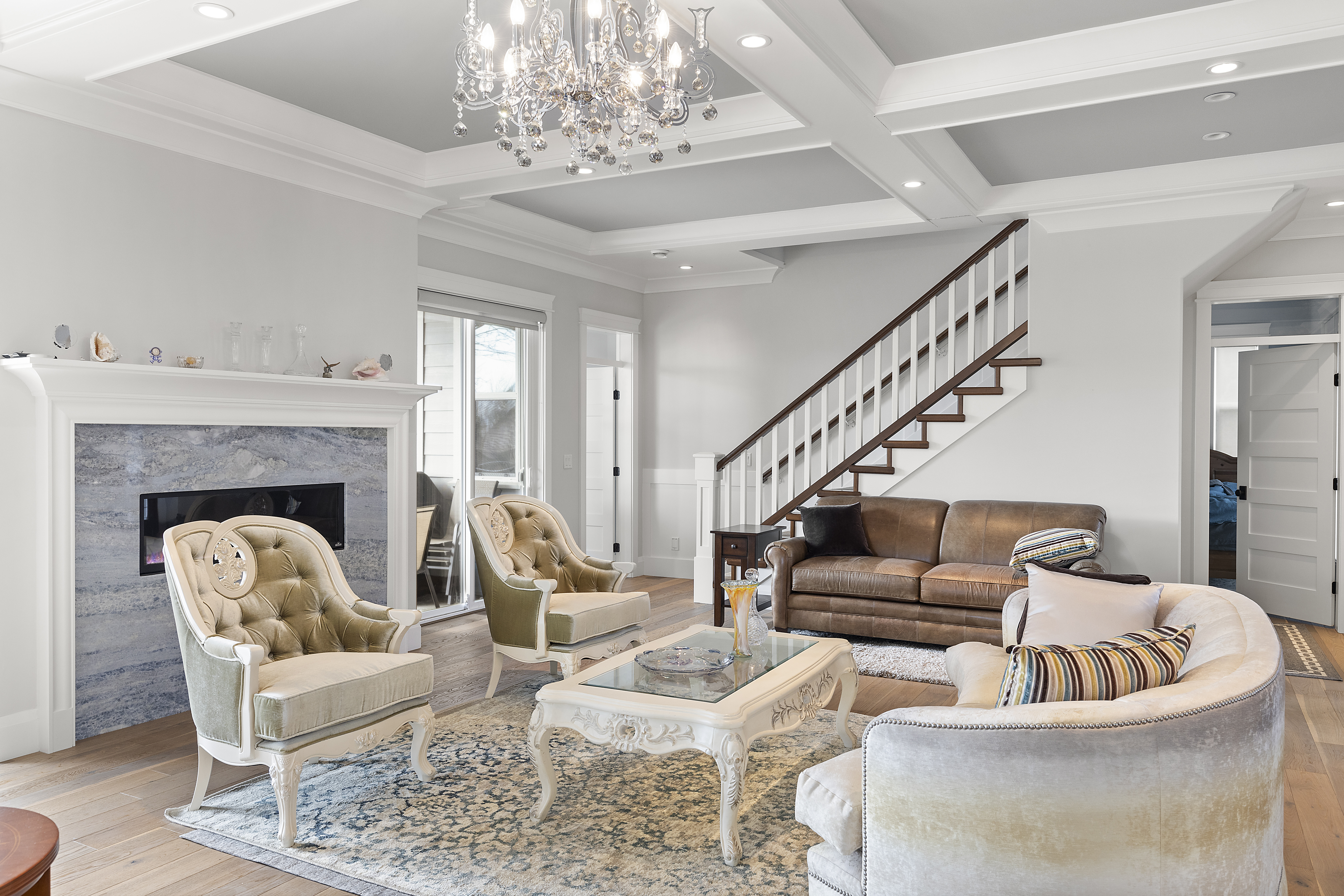 A modern-classic living room with a coffered ceiling and a blend of traditional and contemporary furnishings. Highlights incl