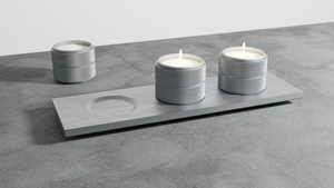 Stainless Steel tealight candle holders on concrete floor.