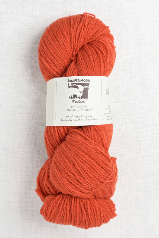 Orange yarn skein with Juniper Moon Farm label