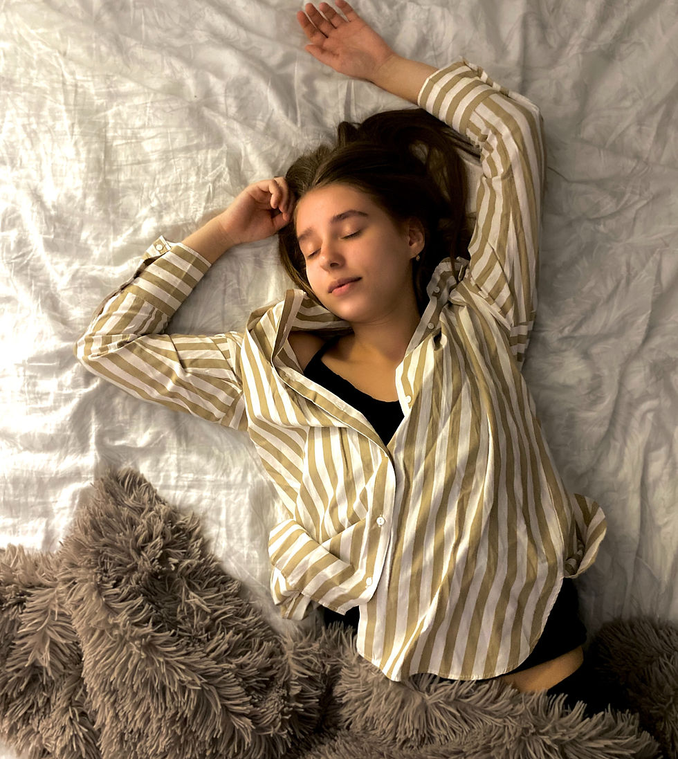 Woman sleeping peacefully in a calm, dimly lit setting, representing rest, relaxation, and nighttime wellness routine