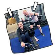Female athlete rowing with male athlete supporting her during CrossFit workout