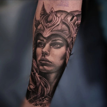 Viking woman in helmet, tattoo on arm