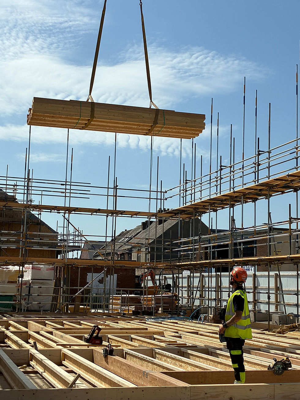 Construction workers installing timber frames on a residential building site