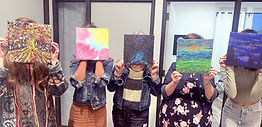 Participants holding their paintings