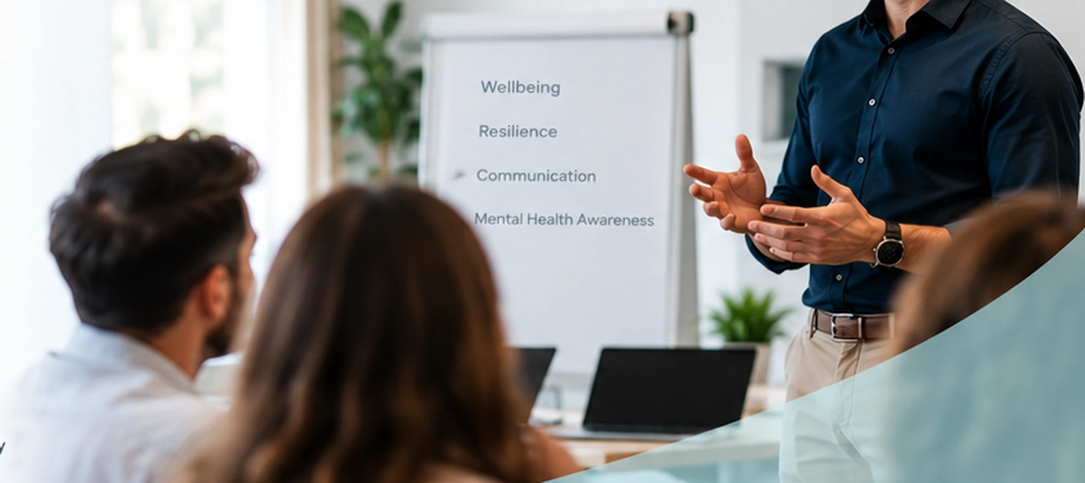 Illustrative wellbeing workshop with a facilitator presenting to a small group of adults