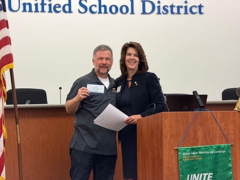Four Peaks Rotary Foundation President, Scott Sommer, accepts a $2,500 check from Clason Communications at the club's February 26 meeting.