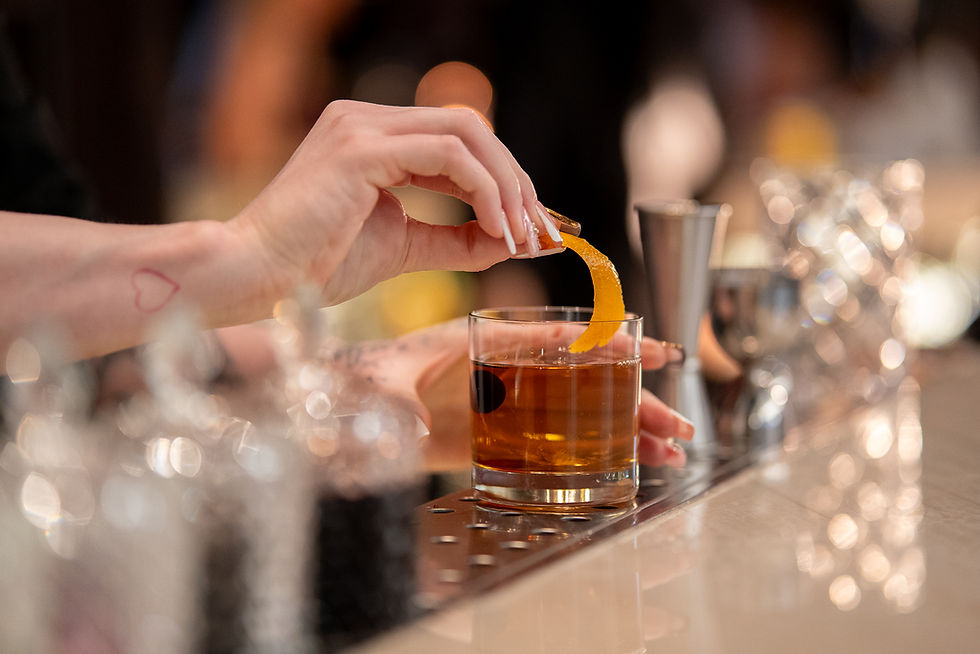 Bartender making Liam_s House Old Fashioned.