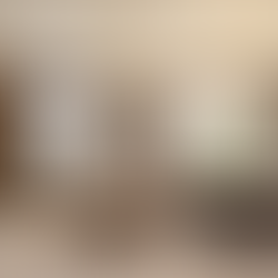 Modern living-dining area with beige sofa, large windows, elegant light fixtures, a dining table set for 8, and a TV on marble wall.