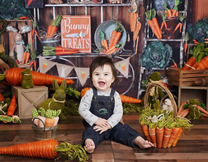 Image of 3 children in a spring garden-themed with Easter decorations
