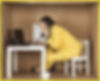 picture of a moving company sales rep sitting on a small chair and on the phone.