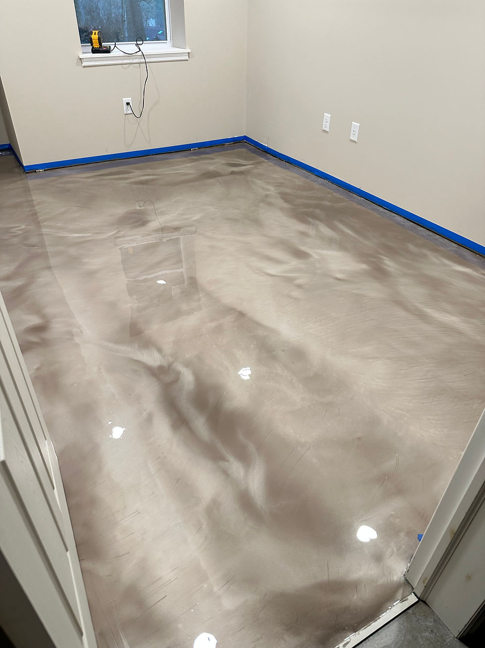 Metallic epoxy flooring with a glossy marble effect
