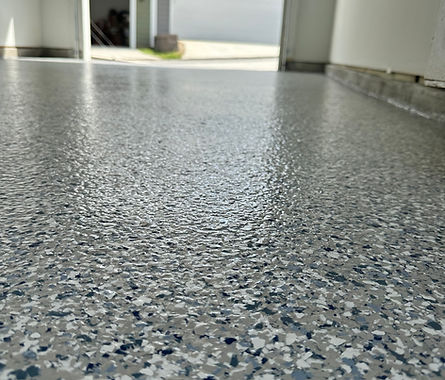 Glossy garage floor with blue and grey epoxy