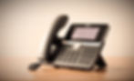 yealink t46u desktop phone with headset against blurred plain background_edited.jpg