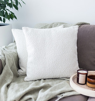 A soft purple couch with white throw pillows representing in-person therapy in Memphis, TN