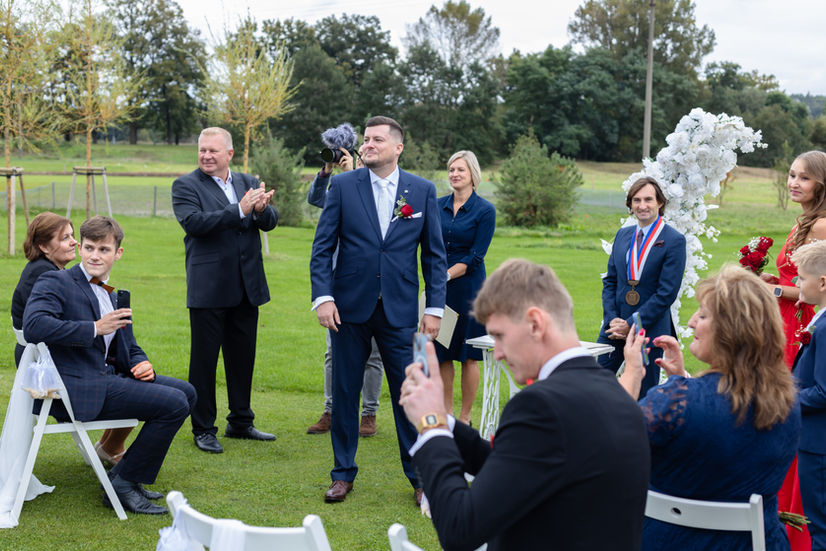 Groom and wedding guests at a luxury outdoor ceremony in Stratford-upon-Avon, professional candid wedding photography.