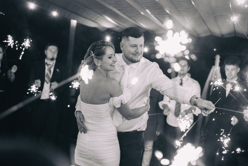 Black and white sparkler photography in Lichfield, capturing a romantic moment between newlyweds during a luxury evening reception.
