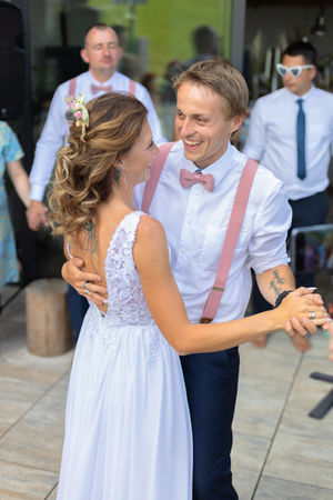 Professional wedding photography in Cheshire showing the joyful reactions of guests as the newlyweds have their first dance on a scenic outdoor terrace.