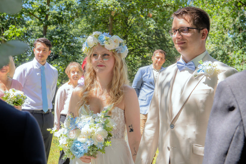 Luxury outdoor wedding photography in Knutsford, featuring a bride with a flower crown and groom during a romantic forest ceremony.