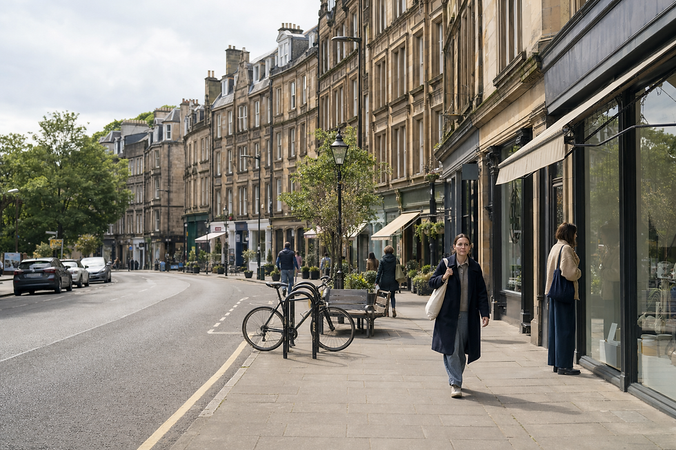 A woman walks along a charming street lined with historical buildings and shops on a cloudy day.