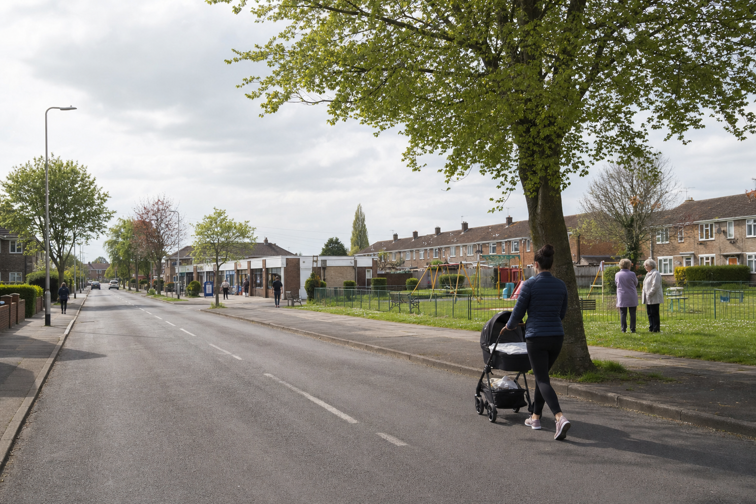 A woman pushes a pram along a quiet residential street with shops and a playground nearby.