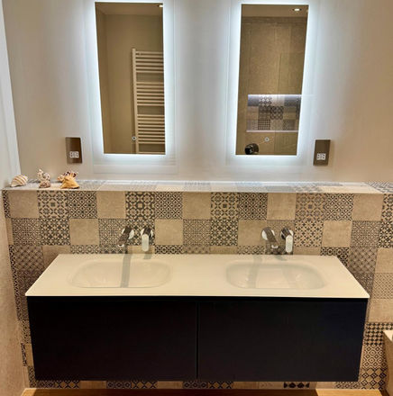 Bathroom with two illuminated mirrors and a modern vanity sink Westcountry Tile