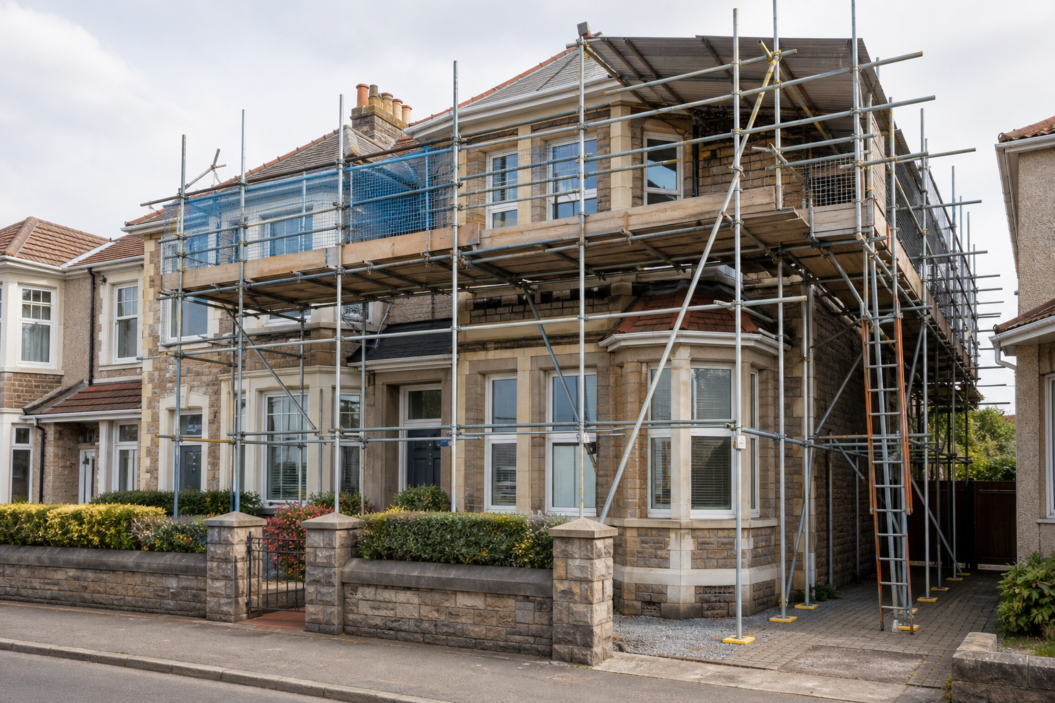 House under renovation with scaffolding covering the facade.