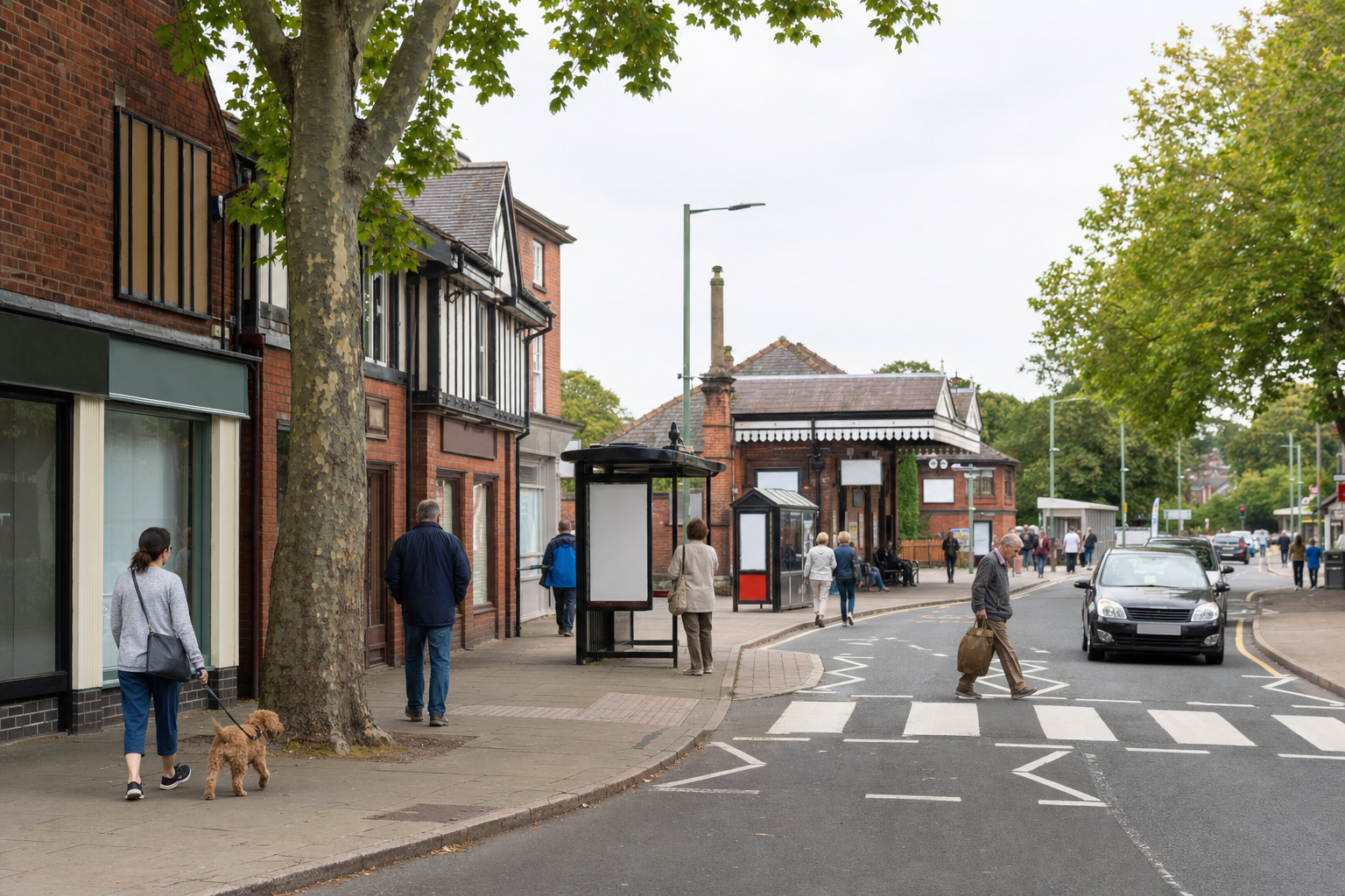 A street scene with people walking and a man crossing a zebra crossing near a row of shops and a bus stop.