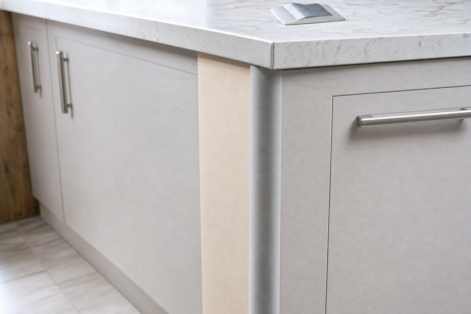Modern kitchen countertop with sleek grey cabinets and metallic handles.