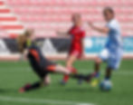 Female footballers and goalkeeper