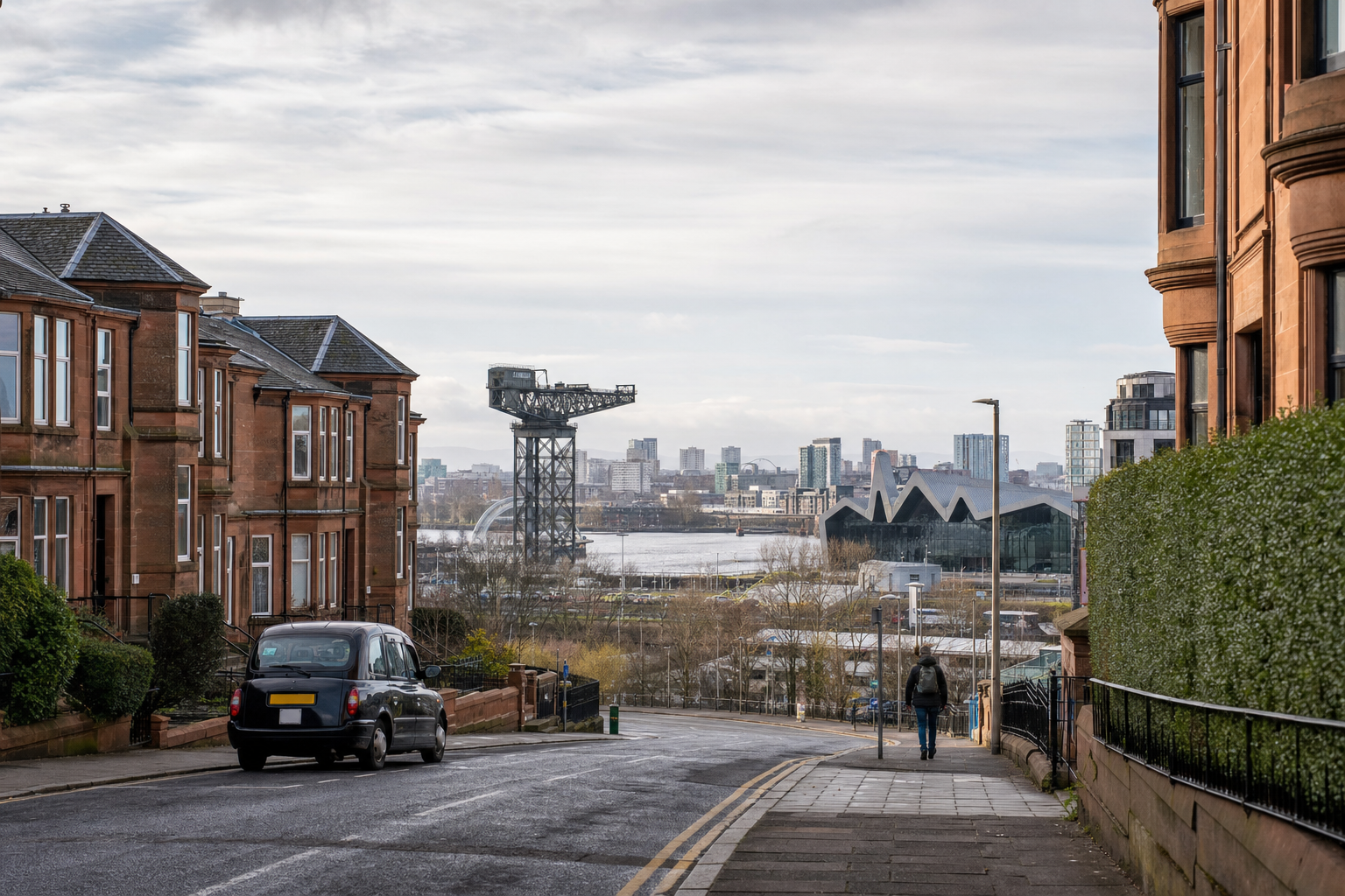 Street view of Glasgow with historic buildings, a lone pedestrian, a black cab, and a backdrop of modern city architecture.