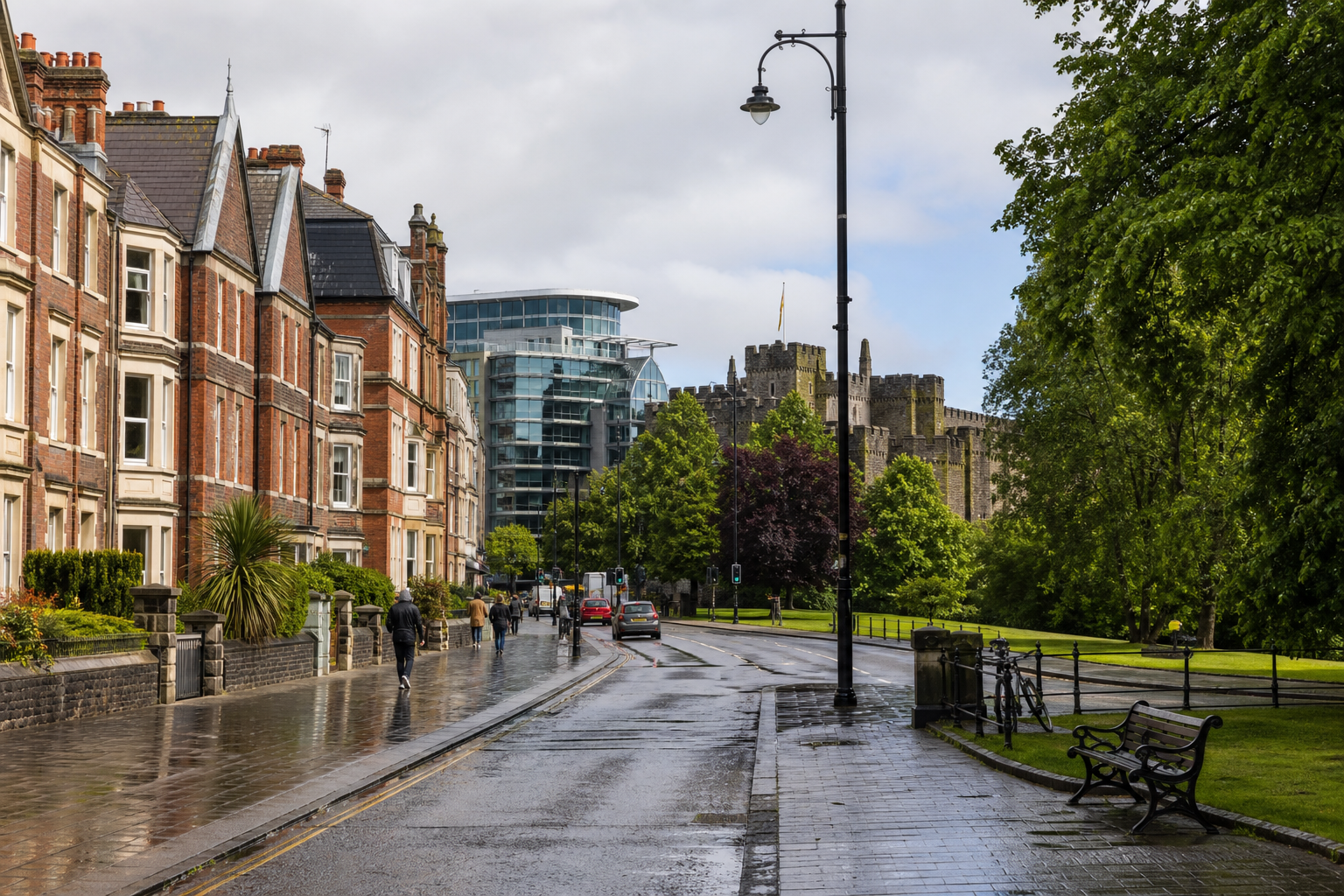 A wet pavement lined with Victorian houses leads to a castle, with a modern glass building visible in the background.