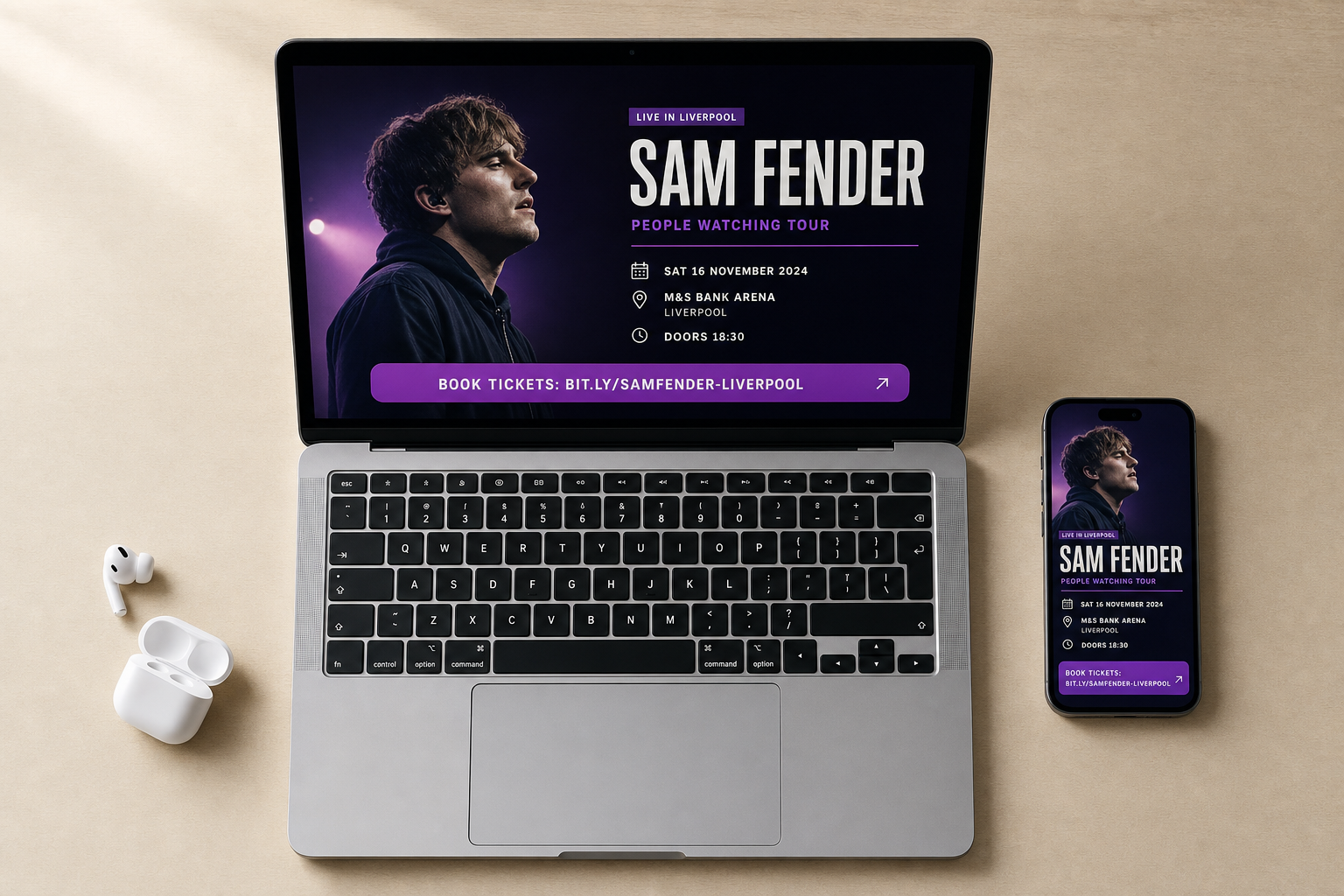 Laptop and smartphone displaying information about Sam Fender's Liverpool concert, with wireless earbuds nearby.