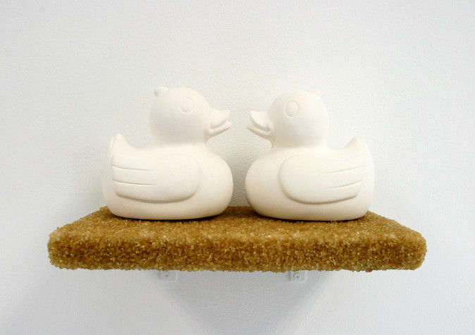 Artwork from series titled 'Purity and Danger' by fine artist Pernille Holm showing two plaster cast ducks on a sugar-coated shelf