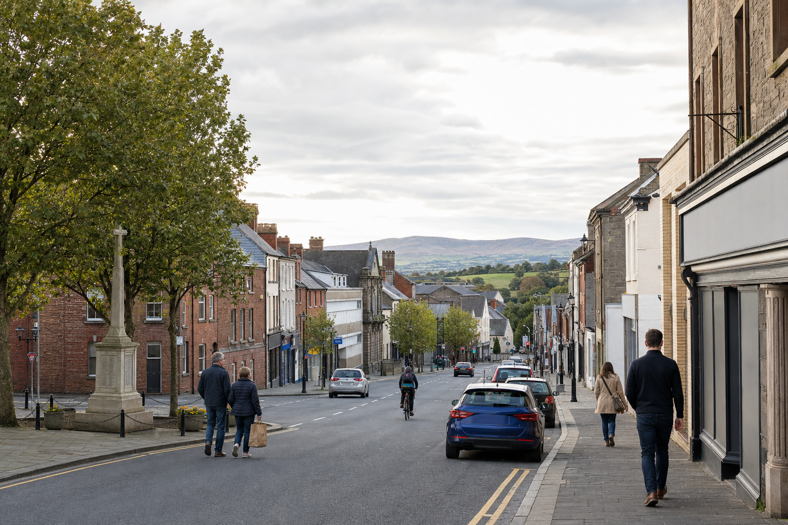 A quiet street scene with people walking and a cyclist, lined with cars and historic buildings, overlooks distant hills.
