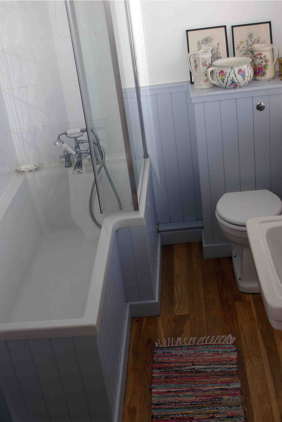 Bathroom installation with tongue and groove panelling and reclaimed oak floor