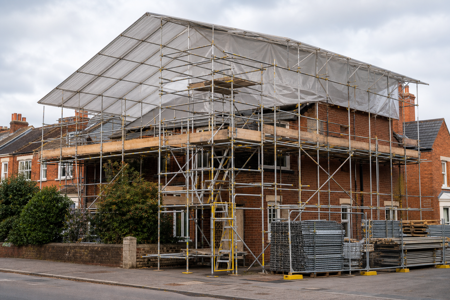 House under renovation with scaffolding and a temporary roof cover.