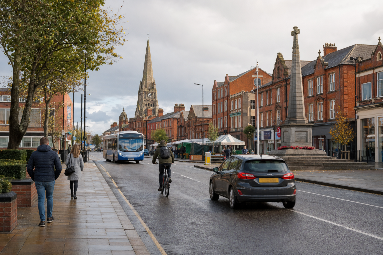 Street scene with people walking, a cyclist, a car, a bus, and a church spire in the background.