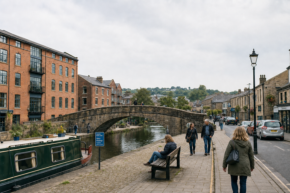 People walking by a canal with a stone bridge and brick buildings in the background on a cloudy day.