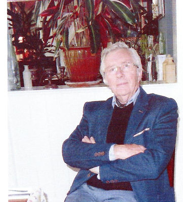 A senior man sitting in a chair with his arms crossed