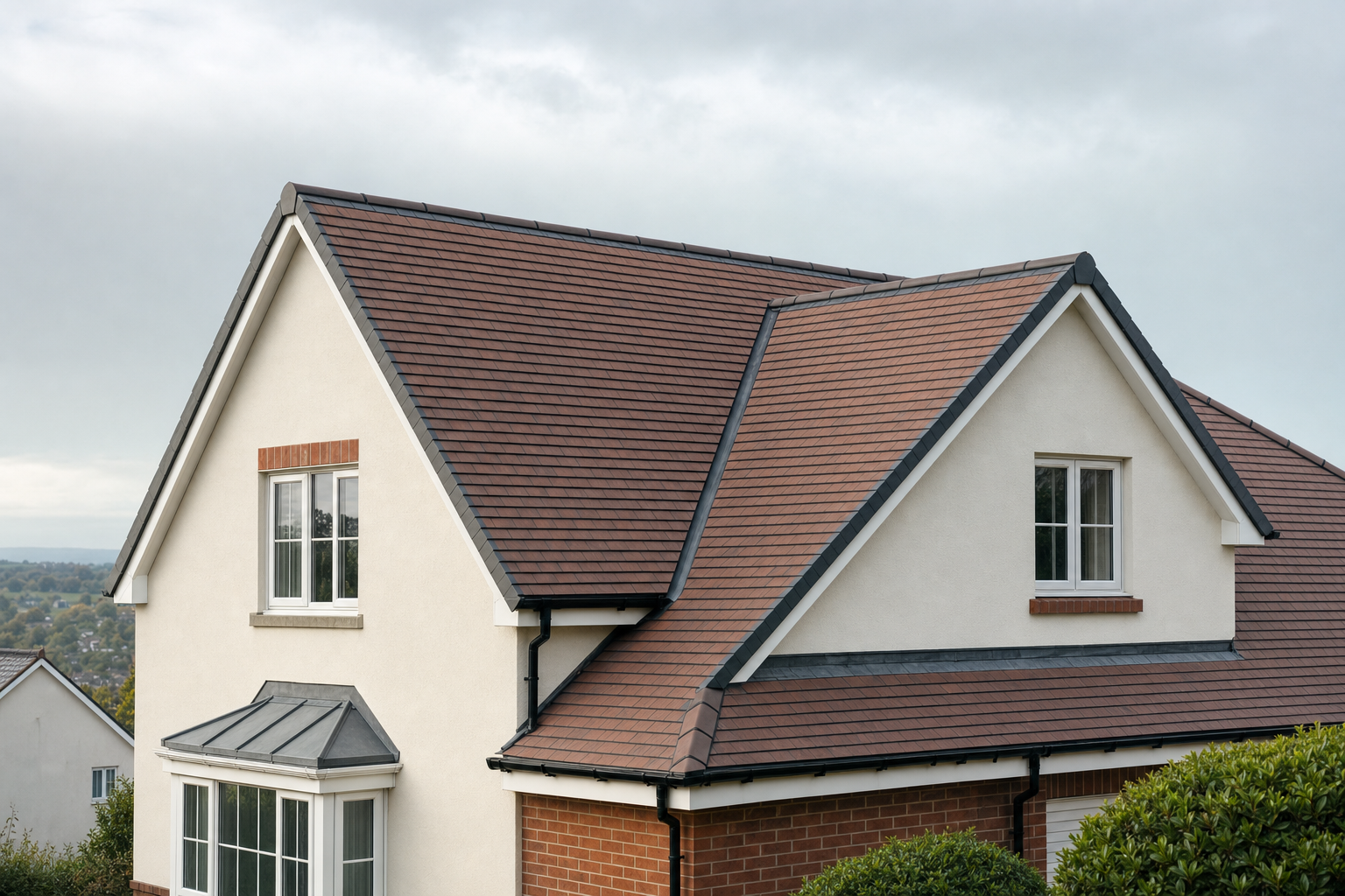 Modern house with a red-tiled roof, white plaster walls, and a bay window under a cloudy sky.