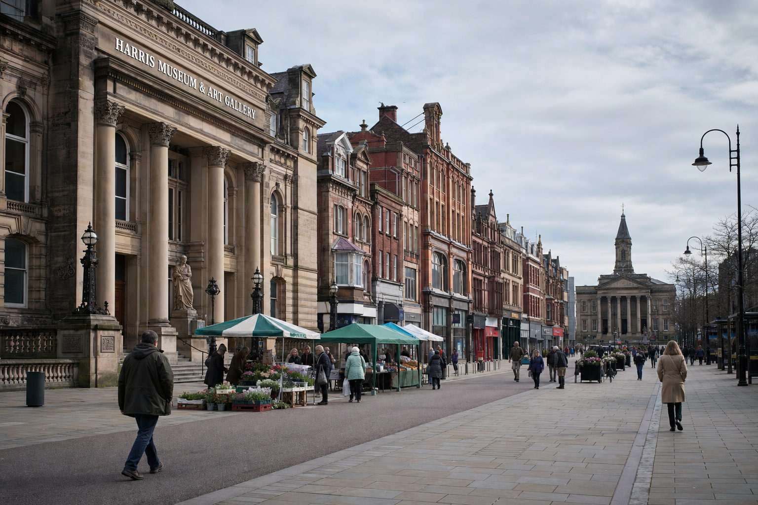 Busy street with people walking past the Harris Museum and Art Gallery in a historic city centre.