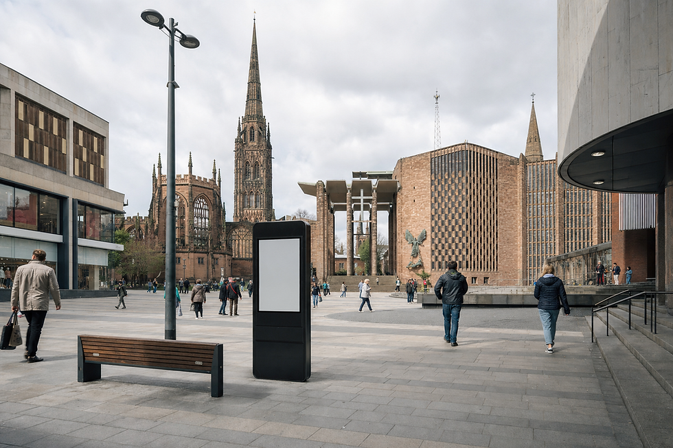 People walking in a public square with a cathedral and modern buildings in the background.