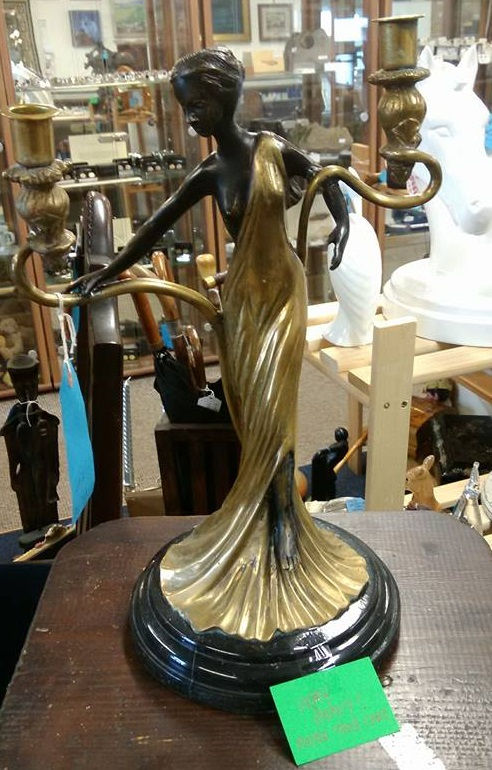 A bronze candlestick on marble base by Romain de Tirtoff ,1892-1990 at £150.00