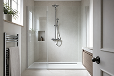 Modern bathroom with a glass-door shower, grey tiles, towel rail, and a small window with a potted plant.