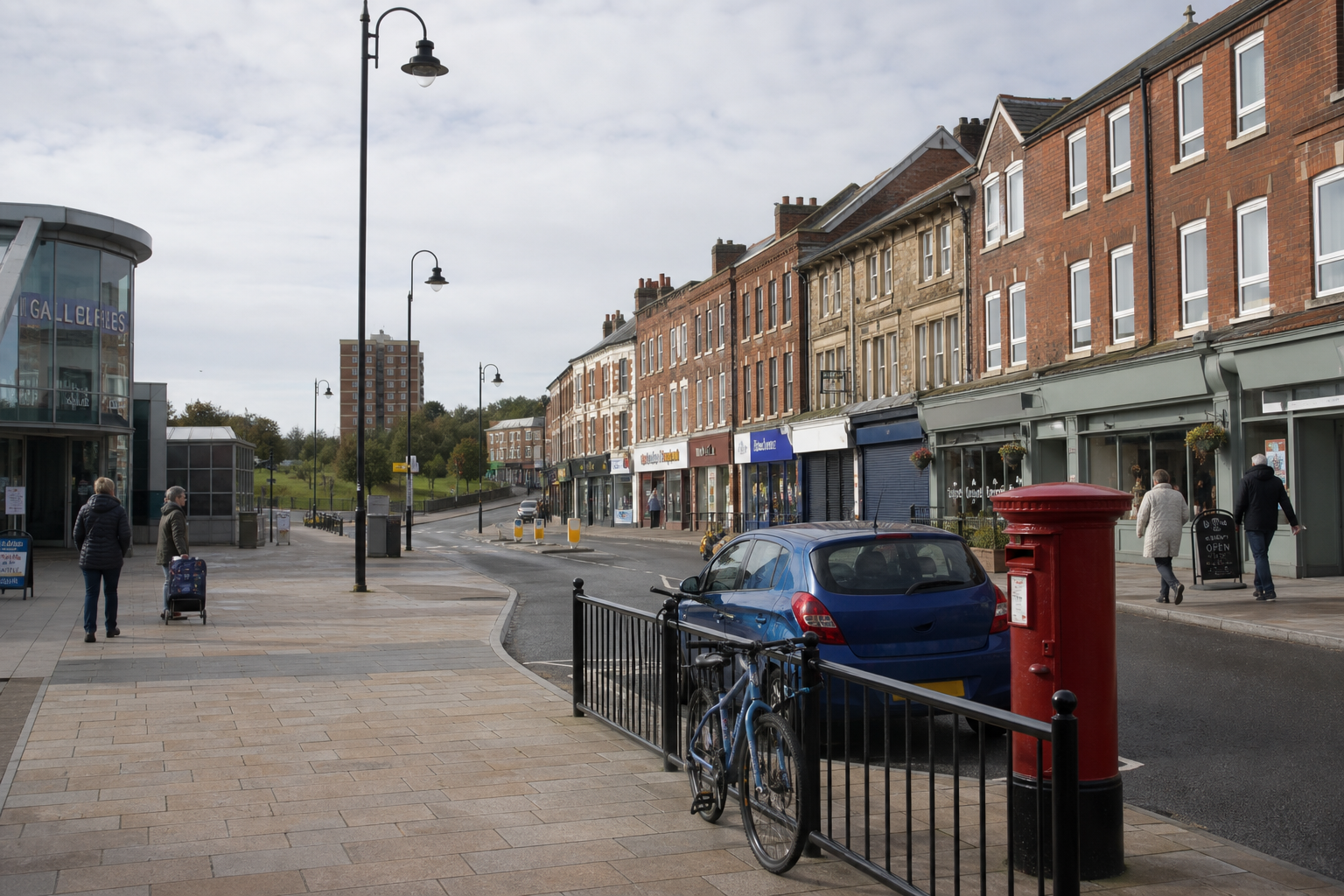 Street view with parked car, bicycle, red post box, and people walking on a quiet day.