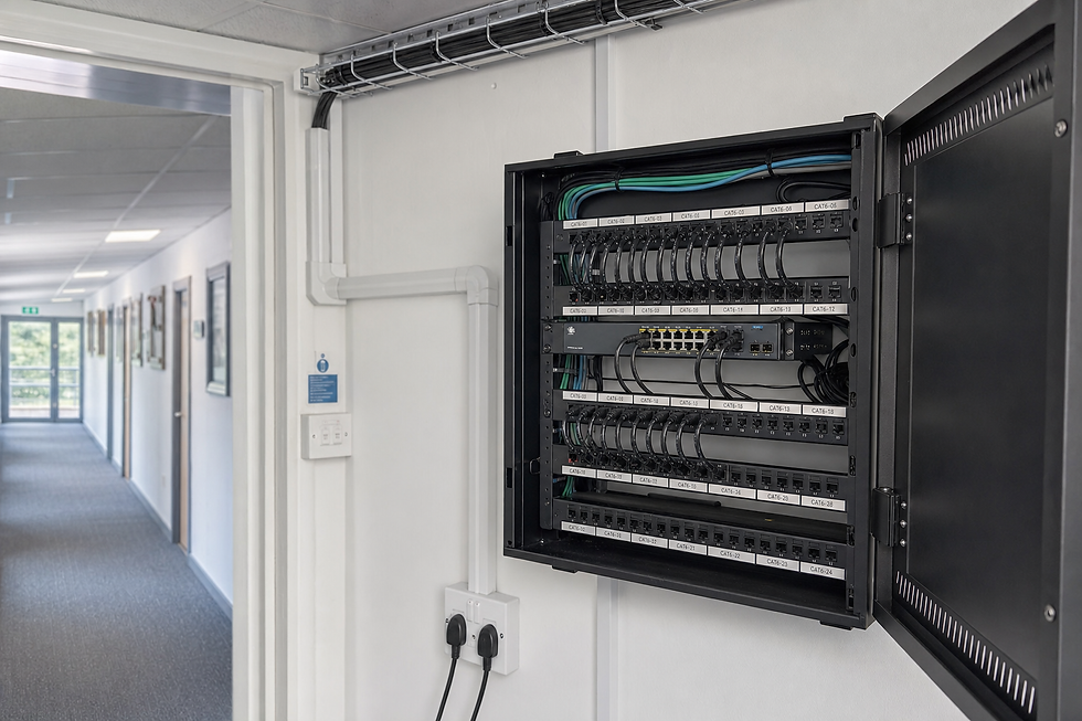 Open network patch panel cabinet mounted on office corridor wall