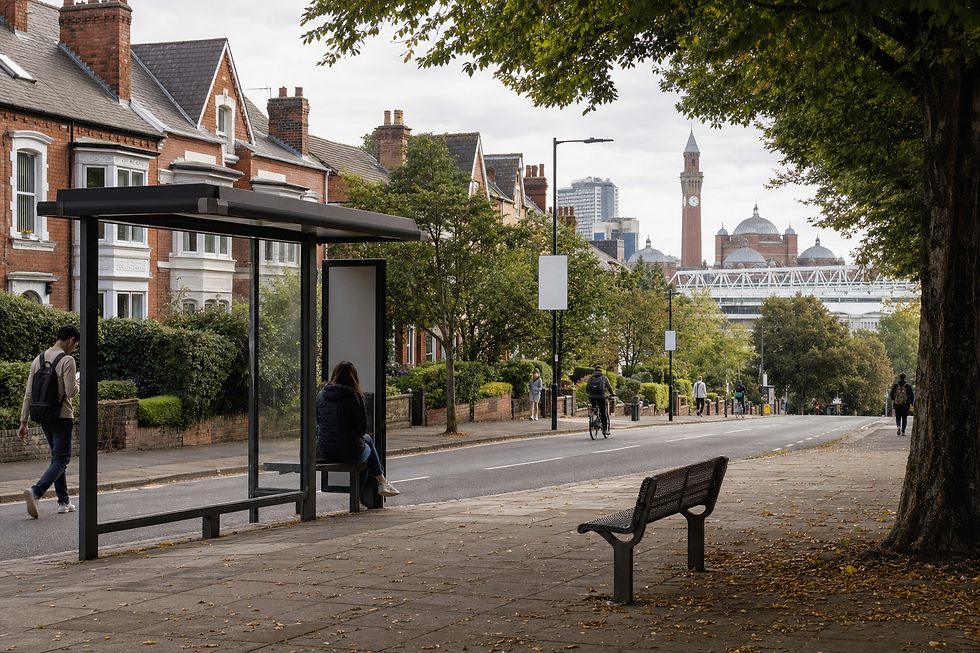 People walking and cycling near a bus shelter on a tree-lined street with red-brick houses and a clock tower in the